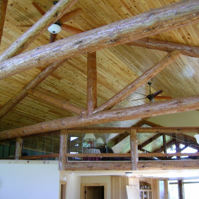 interior log trusses insisde of a home witha loft